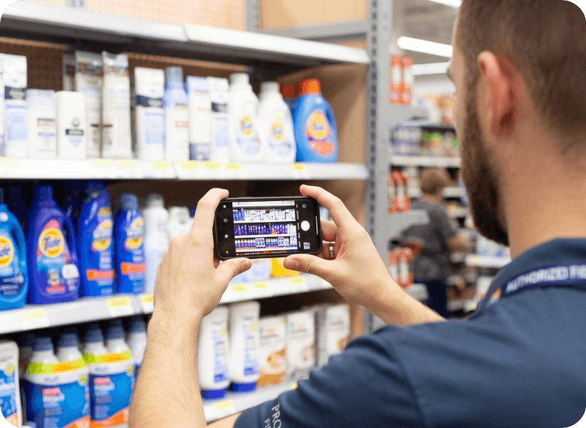 A field representative capturing a shelf with a phone